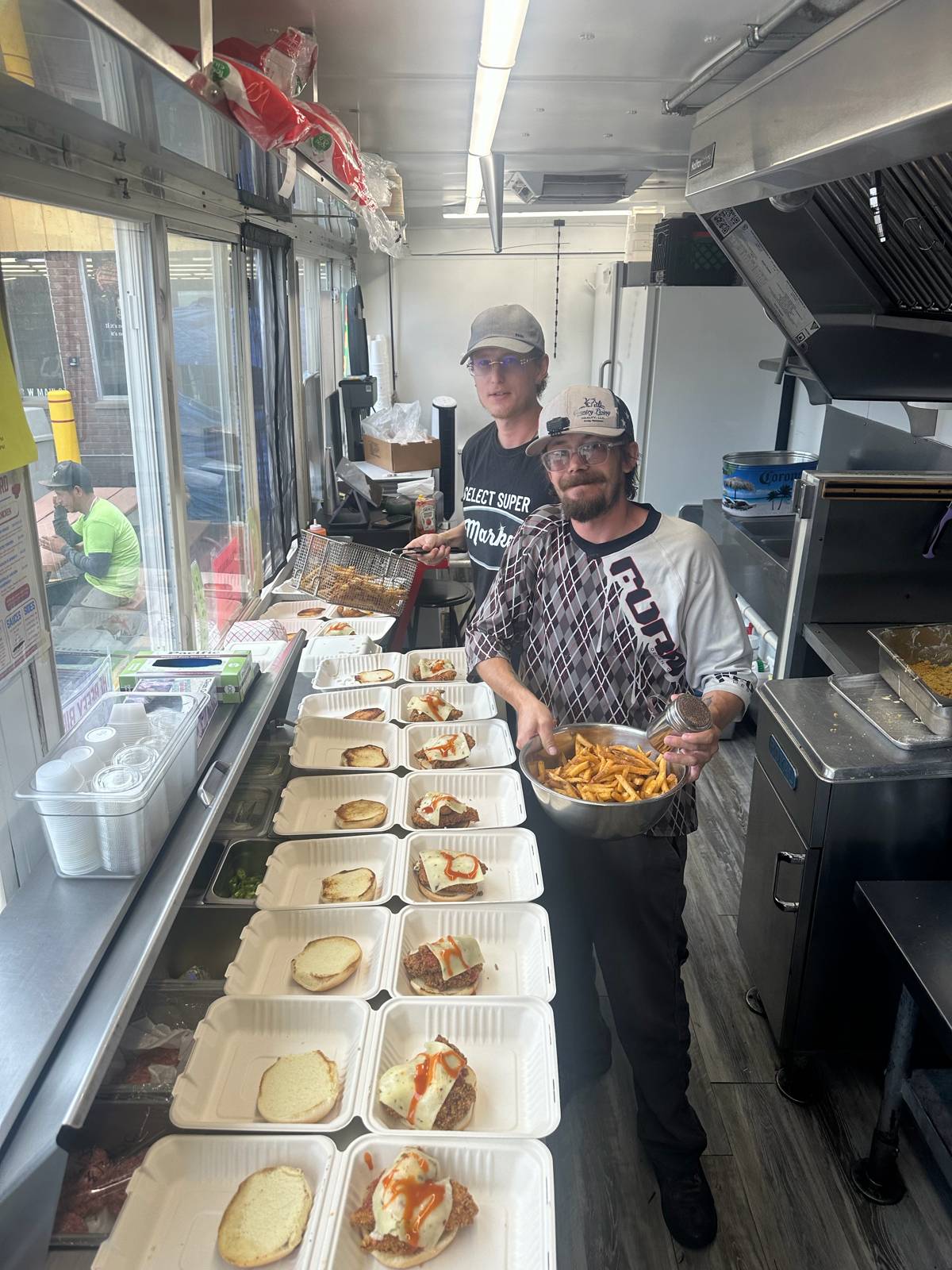 The Beefy Bird crew in the truck with a row of orders ready
